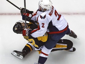 Pittsburgh Penguins' Sidney Crosby takes a hit from Washington Capitals' Matt Niskanen during the first period of Game 3 in an NHL Stanley Cup Eastern Conference semifinal hockey game in Pittsburgh on Monday, May 1, 2017.