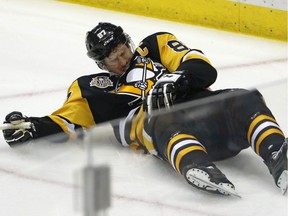 Pittsburgh Penguins' Sidney Crosby (87) lies on the ice after taking a hit on May 1, 2017. The Penguins captain who suffered what is believed to be the fourth concussion of his NHL career.
