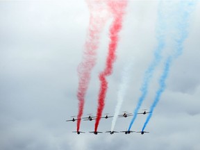 The Canadian Forces Snowbirds and the Patrouille de France air demonstration team conduct a joint flyby over Parliament Hill in Ottawa in Ottawa on Tuesday, May 2, 2017.