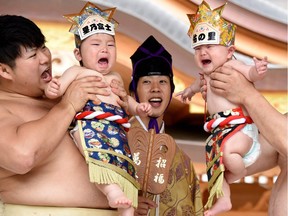 Photo of the day: Sumo wresters hold up crying babies in front of a referee (centre) clad in a traditional costume during a "Baby-cry Sumo" event at the Kamegaike-Hachiman Shrine in Sagamihara, Kanagawa prefecture, May 14, 2017. One hundred and fifty babies aged took part in the annual baby crying contest in the Shinto shrine in Sagamihara. Some Japanese parents believe that sumo wrestlers can help make babies cry out a wish to grow up with good health.