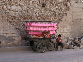 Photo of the day: A Syrian child eats candy floss while selling it on a street cart in the Syrian city of al-Bab in the northern Aleppo province, May 15, 2017.