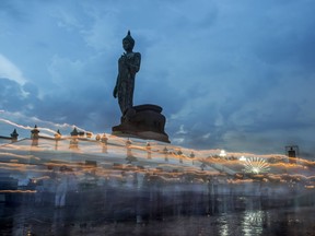 Photo of the day: Streaks of light from candles mark the path followers of Bhuddism take as they walk around the giant statue of Lord Bhudda at the Phutthamonthon near Bangkok. They are celebrating Vesak Day, which marks the birth of Gautama Buddha, the father of Buddhism, May 10, 2017.