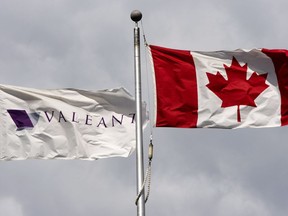 Valeant Pharmaceuticals' corporate flag and the Canadian flag fly outside the company's corporate headquarters in Laval.