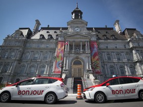 Taxis wait outside Montreal city hall.