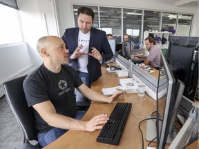 Jean-Francois Gagné, right, CEO of Element AI, checks in with engineer Philippe Mathieu in the company's offices in Montreal.