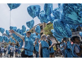 People with balloons take part in the annual Féte Nationale parade in Montreal in 2016.
