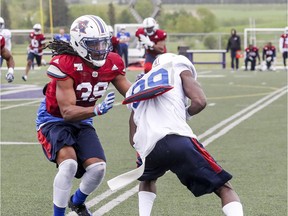 Defensive back Donald Unamba Jr., left, stops reciever T.J. Graham during Montreal Alouettes training camp at Bishop's University in Lennoxville, southeast of Montreal on Monday, May 29, 2017.