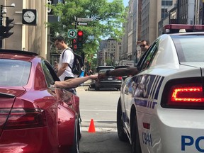 A photo capturing a fist bump between a Montreal police officer and custom car fan over Grand Prix weekend has been shared widely on social media.
