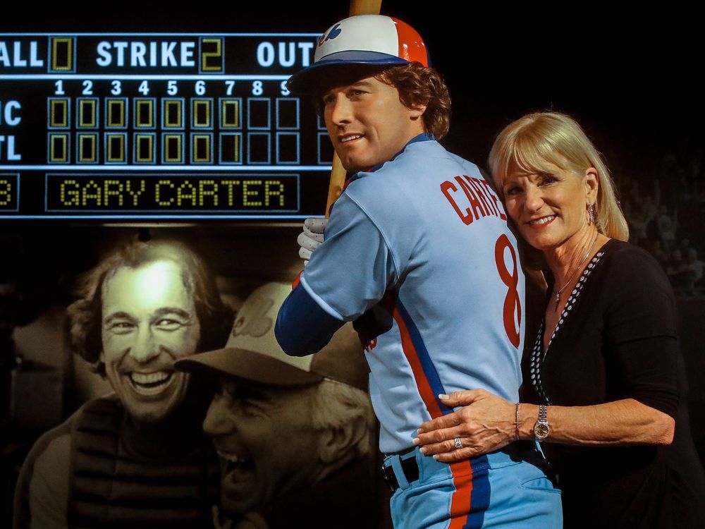 Sandy Carter, wife of former Montreal Expos Gary Carter, and her daughter  Kimmy acknowledge applauds from the crowd during a ceremony prior to a  pre-season game between the Toronto Blue Jays and