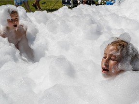 The beach at Parc Jean-Drapeau is open and kids like seven-year-old Heidi, right, and her nine-year-old brother Alexis were having fun at the foam party in Montreal, on Sunday, June 25, 2017.