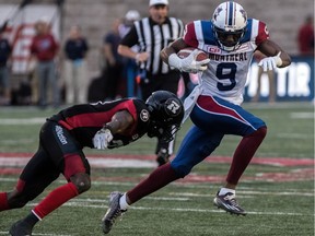 Alouettes wide-receiver Ernest Jackson evades Redblacks player during CFL action at Molson Stadium on Thursday, June 15, 2017.