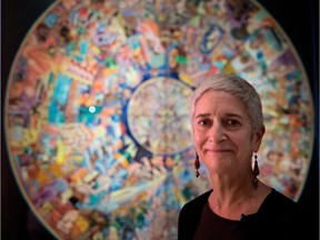 Montreal Museum of Fine Arts curator Diane Charbonneau stands in front of a piece called Grain of Sand, by Abdul Mati Klarwein, in the Revolution exhibit, on Tuesday, June 13, 2017.