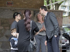 Jean-François Roberge, right, local MNA for the Coalition Avenir Québec, with parents Christophe Vasseur, left, and Iris Le Bescomb, second from left, with their seven-year-old son Guillaume and another parent, Christelle Perrine, second right, in front of Marguerite-Bourgeoys school on June 20, 2017.