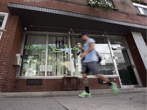 A man walks past Spectre de rue, a drug prevention and intervention centre on Ontario Street East in Montreal, June 20, 2017. Three safe injection sites are being inaugurated Monday at 11 a.m. at the CLSC des Faubourgs on Ste-Catherine St. E.