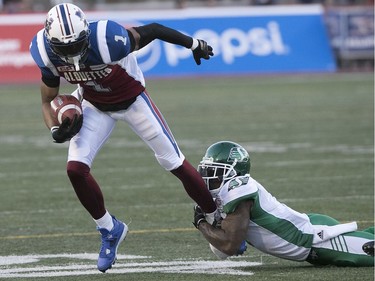 Montreal Alouettes' Tiquan Underwood is brought down by Saskatchewan Roughriders's Jovon Johnson during second quarter action in Montreal on Thursday June 22, 2017.