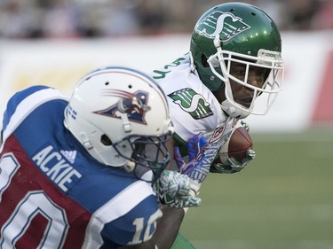 Montreal Alouettes' Chris Ackie tackles Saskatchewan Roughriders's Duron Carter during second quarter action in Montreal on Thursday June 22, 2017.