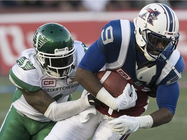 Montreal Alouettes's Ernest Jackson away from Saskatchewan Roughriders's Jovon Johnson during second- quarter action in Montreal on Thursday, June 22, 2017.
