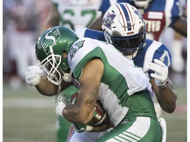 Saskatchewan Roughriders's Nic Demski is taken down by Montreal Alouettes's John Bowman during second quarter action in Montreal on Thursday June 22, 2017.