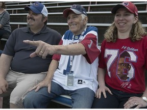Tony Evans, centre, daughter Lisa Evans and her husband David Furey watch the Montreal Alouettes warm up at Molson Stadium on  Thursday, June 22, 2017.