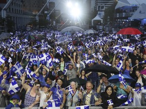 Umbrellas and Quebec flags where out in full force minutes before the Grand Spectacle de la Fete Nationale in Montreal on Friday June 23, 2017. (Pierre Obendrauf / MONTREAL GAZETTE)