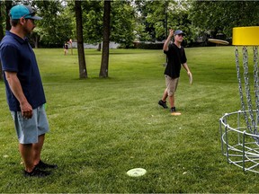 Dorval inaugurated the first disc-golf course on its territory, located at Windsor Park on Sunday, June 25, 2017. Charles Blanchette, left, currently first in Open Division of the Quebec Disc-Golf Tour 2017 and course designer Michel St-Pierre, Albatroz Disc-Golf, looks on. St-Pierre has designed about 10 disc-golf courses in Quebec.