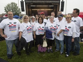 Residents of Macons St. pose prior to a concert Thursday night with OSM musical director Kent Nagano on behalf of all residents affected by spring flooding in the Pierrefonds-Roxboro borough.
