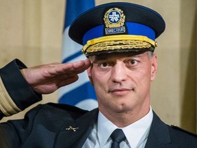 Philippe Pichet salutes during his swearing in as chief of Montreal police at a ceremony at Montreal City Hall on Friday, August 28, 2015. He was suspended after a scathing report about the police department's management was released by the provincial government.