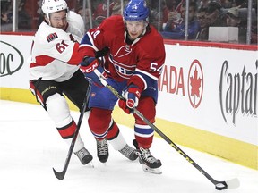 Canadiens' Charles Hudon is checked by Senators' Mark Stone during preseason game in 2015.