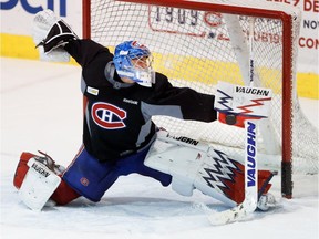 Montreal Canadiens goalie Charlie Lindgren stops the puck with the side of his blocker during a team practice at the Bell Sports Complex in Montreal on Monday October 17, 2016.