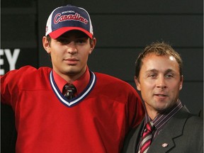 Fifth overall draft pick Carey Price poses with director of player personnel Trevor Timmins after being selected during the 2005 National Hockey League Draft.