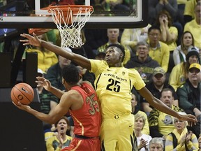 Chris Boucher #25 of the Oregon Ducks blocks the shot of Allonzo Trier of the Arizona Wildcats during the first half of the game at Matthew Knight Arena on February 4, 2017 in Eugene, Oregon. Oregon won the game 85-58.