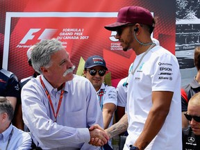 Chase Carey, CEO and executive chairman of the Formula One Group, greets Mercedes driver Lewis Hamilton before the Canadian Grand Prix at Circuit Gilles Villeneuve on June 11.