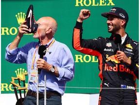 Actor Sir Patrick Stewart celebrates on the podium with Daniel Ricciardo of Australia and Red Bull Racing and a shoey during the Canadian Formula One Grand Prix at Circuit Gilles Villeneuve on June 11, 2017 in Montreal, Canada.  (Photo by Dan Istitene/Getty Images)