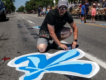 Last-minute preparations by Martin Bernier are made along the Montreal Fête nationale parade route on St-Denis St. on Saturday, June 24, 2017.