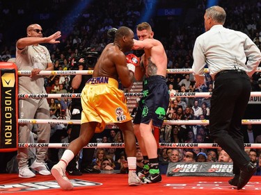 Andrzej Fonfara's trainer Virgil Hunter (left) calls an end to the bout during the WBC light heavyweight world championship match against Adonis Stevenson at the Bell Centre on June 3, 2017 in Montreal, Quebec, Canada.  Adonis Stevenson defeated Andrzej Fonfara in the second round by way of technical knockout.