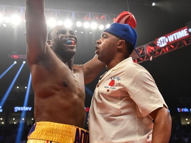 Adonis Stevenson (left) reacts with trainer SugarHill Steward (right) after defeating Andrzej Fonfara in the second round during the WBC light heavyweight world championship match at the Bell Centre on June 3, 2017 in Montreal, Quebec, Canada.  Adonis Stevenson defeated Andrzej Fonfara in the second round by way of technical knockout.