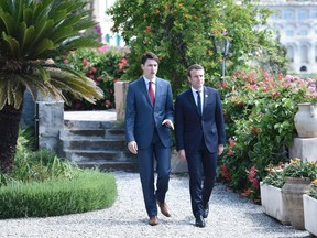 Minister Justin Trudeau (R) and French President Emmanuel Macron talk as they attend the Summit of the Heads of State and of Government of the G7, the group of most industrialized economies, plus the European Union, on May 26, 2017 in Taormina, Sicily.