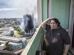 Local resident Georgina stands distraught on her balcony after a fire engulfed the 24-storey Grenfell Tower, in west London, Wednesday June 14, 2017. Fire swept through a high-rise apartment building in west London early Wednesday, killing an unknown number of people with around 50 people being taken to hospital. (Rick Findler/PA via AP) ORG XMIT: LON808

UNITED KINGDOM OUT  NO SALES  NO ARCHIVE  PHOTOGRAPH CANNOT BE STORED OR USED FOR MORE THAN 14 DAYS AFTER THE DAY OF TRANSMISSION
Rick Findler, AP