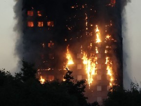 Smoke and flames rise from the 24-storey Grenfell Tower in London, Wednesday, June 14, 2017.