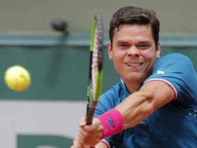 Canada's Milos Raonic plays a shot against Spain's Guillermo Garcia-Lopez during their third round match of the French Open tennis tournament at the Roland Garros stadium, in Paris, France, on Friday, June 2, 2017.