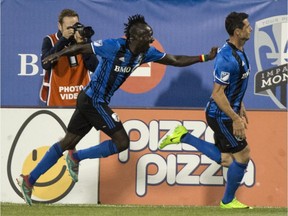 Montreal Impact's Dominic Oduro, left, congratulates teammate Blerim Dzemaili following a goal against the New York Red Bulls during second half MLS action on Saturday, June 3, 2017, in Montreal.