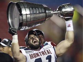 Montreal Alouettes Shea Emry hoists the Grey Cup after the Alouettes beat the Saskatchewan Roughriders 28-27 to win the 97th Grey Cup in Calgary, Sunday November 29, 2009.