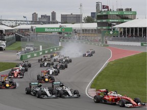 Formula One cars take the first turn at the start of the Formula 1 Canadian Grand Prix at Circuit Gilles Villeneuve in Montreal on Sunday, June 12, 2016.