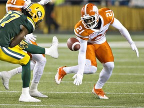 Lions' Ryan Phillips, right, tries to scoop up a loose ball during a game against the Eskimos last year.