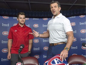 Newly acquired Montreal Canadien Jonathan Drouin, left, gets his jersey from general manager Marc Bergevin as he is introduced to the media during a press conference at the Bell Centre, in Montreal on Thursday, June 15, 2017.