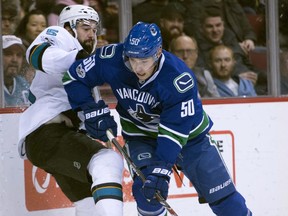 Vancouver Canucks centre Brendan Gaunce (50) fights for control of the puck with San Jose Sharks defenceman David Schlemko (5) during first period NHL action Vancouver, B.C. Saturday, Feb 25, 2017.