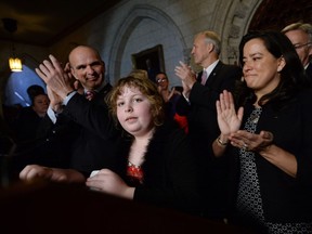 Charlie Lowthian-Rickert, who is transgender, speaks along side Justice Minister Jody Wilson-Raybould, right, as she makes an announcement in the foyer of the House of Commons on Parliament Hill in Ottawa on Tuesday, May 17, 2016, regarding legislation on gender identity and gender expression.
