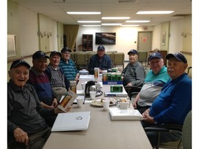 Kirkland councillor John Morson, seated at the head of the table, meets with Chartwell Manoir Kirkland's Gentlemen's Club to discuss world events and organize fundraising events.