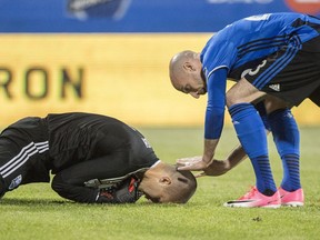 Montreal Impact defender Laurent Ciman congratulates goalkeeper Evan Bush after making a save on a free kick as they face the New York Red Bulls during second half MLS action Saturday, June 3, 2017 in Montreal.