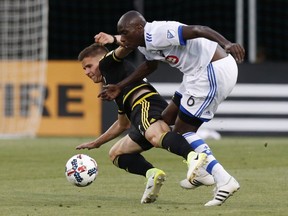 Montreal Impact's Hassoun Camara, right, pushes Columbus Crew's Jukka Raitala to the ground during the second half of an MLS soccer match on Saturday, June 24, 2017, in Columbus, Ohio.